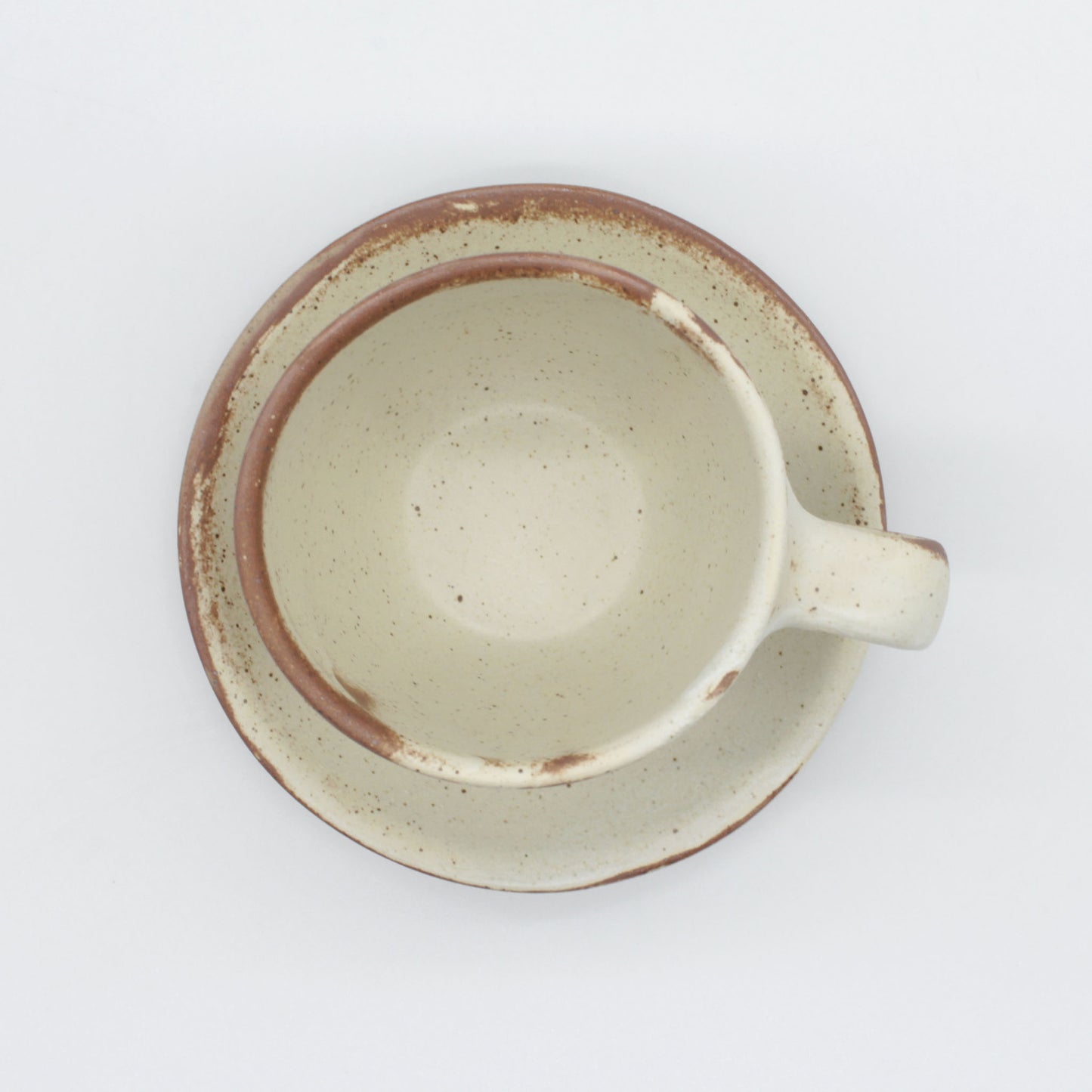 Lotus collection cup and saucer – handmade in antique white colour with touches of clay colour.