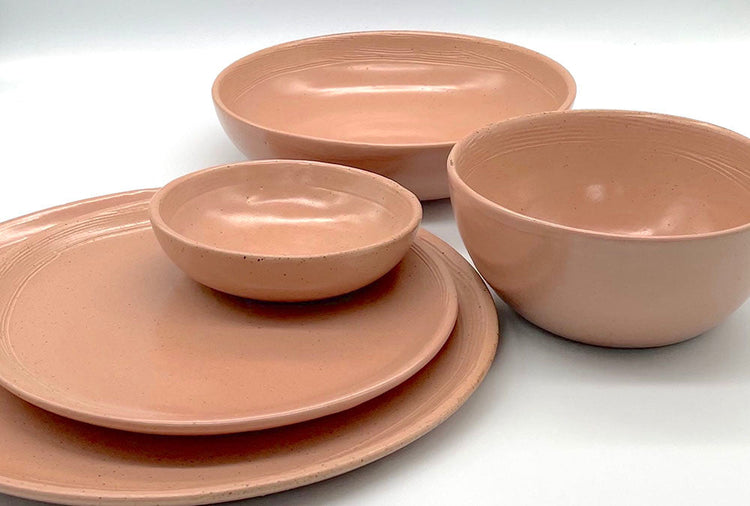 Beautifully handmade ceramic tableware in a peach colour with fine black speckles in the clay.