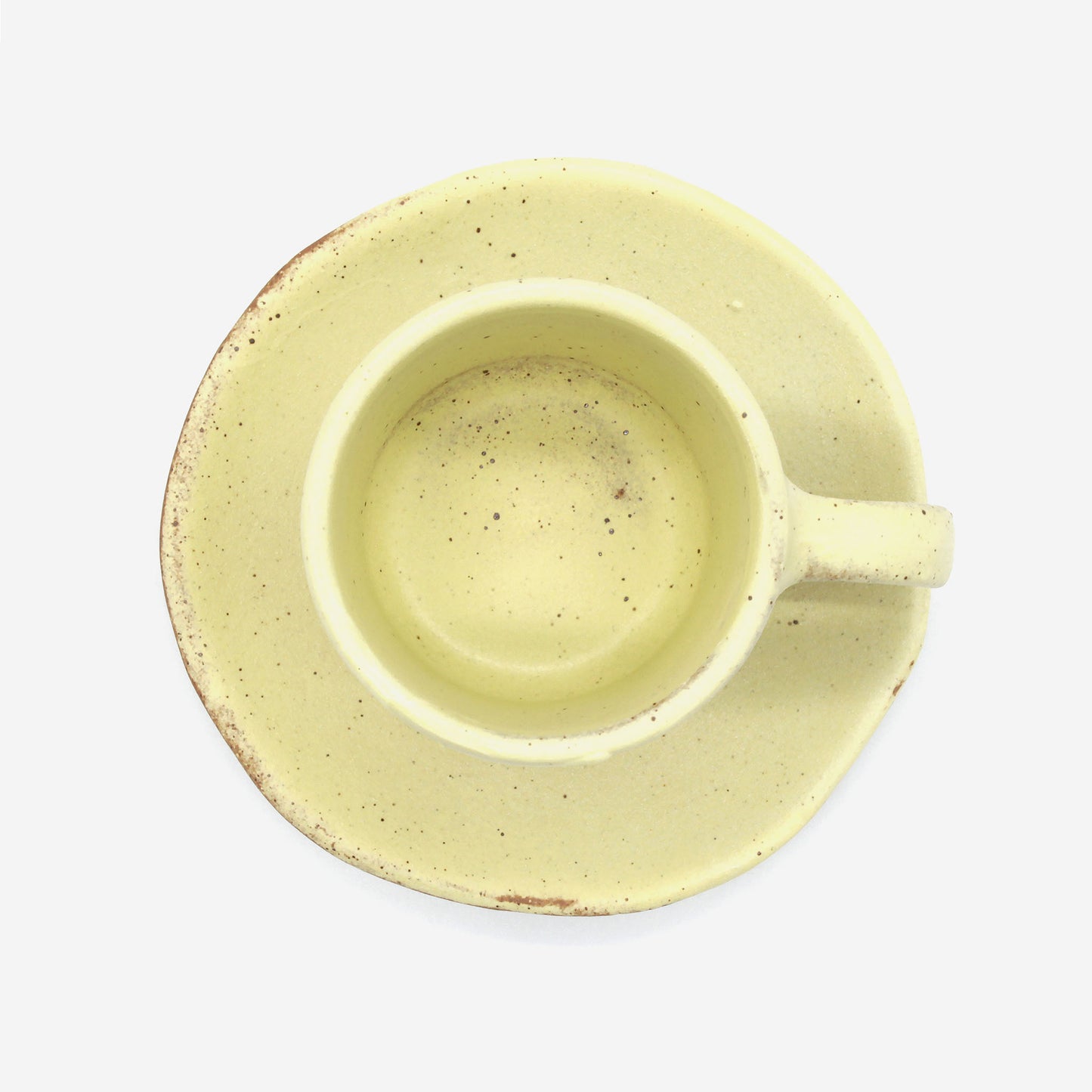 Top view of beautiful handmade double espresso cup from Thailand, yellow colour and natural clay rustic look