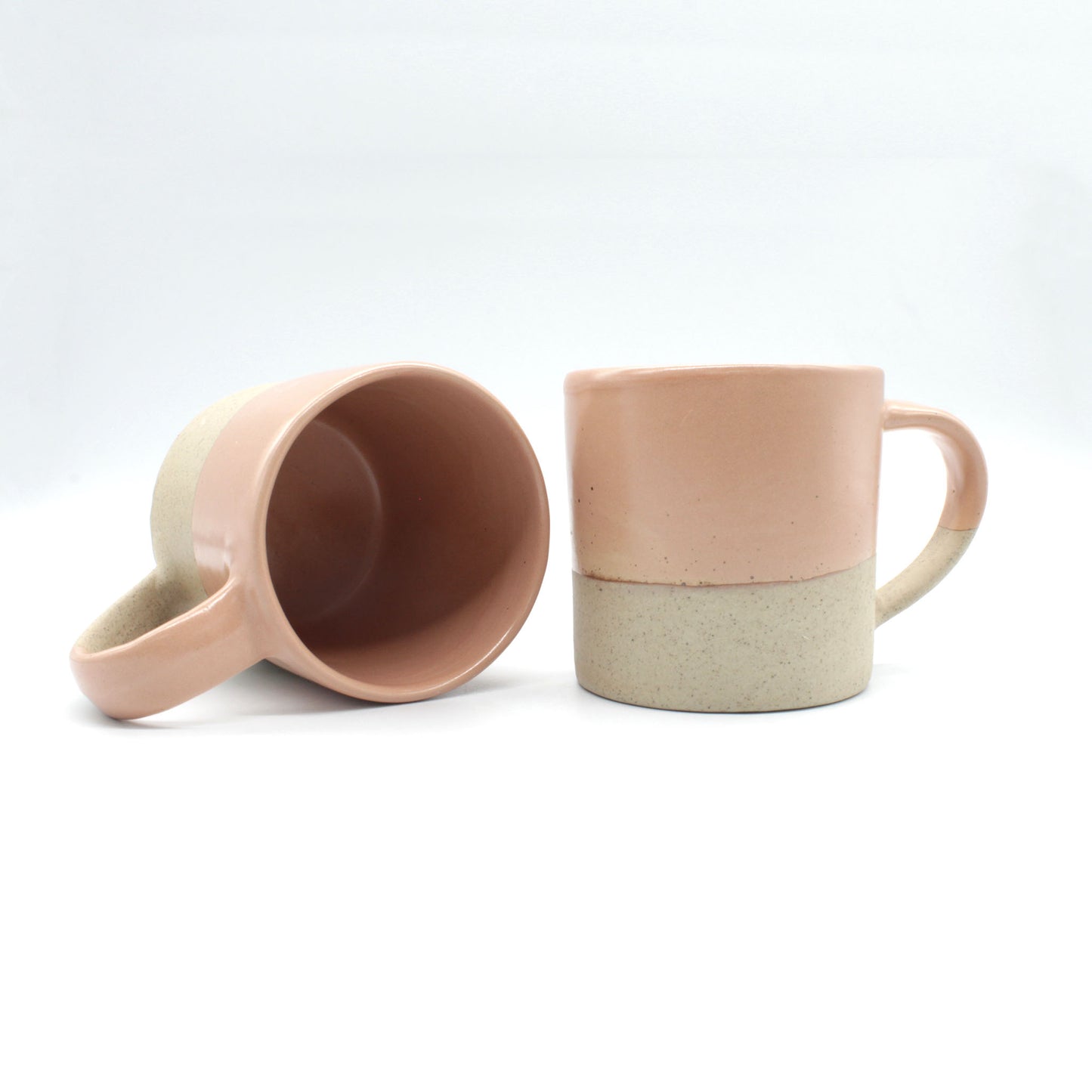 Handmade two-tone mugs from our Isariya collection, Peach colour and pale clay colour with fine black speckles.