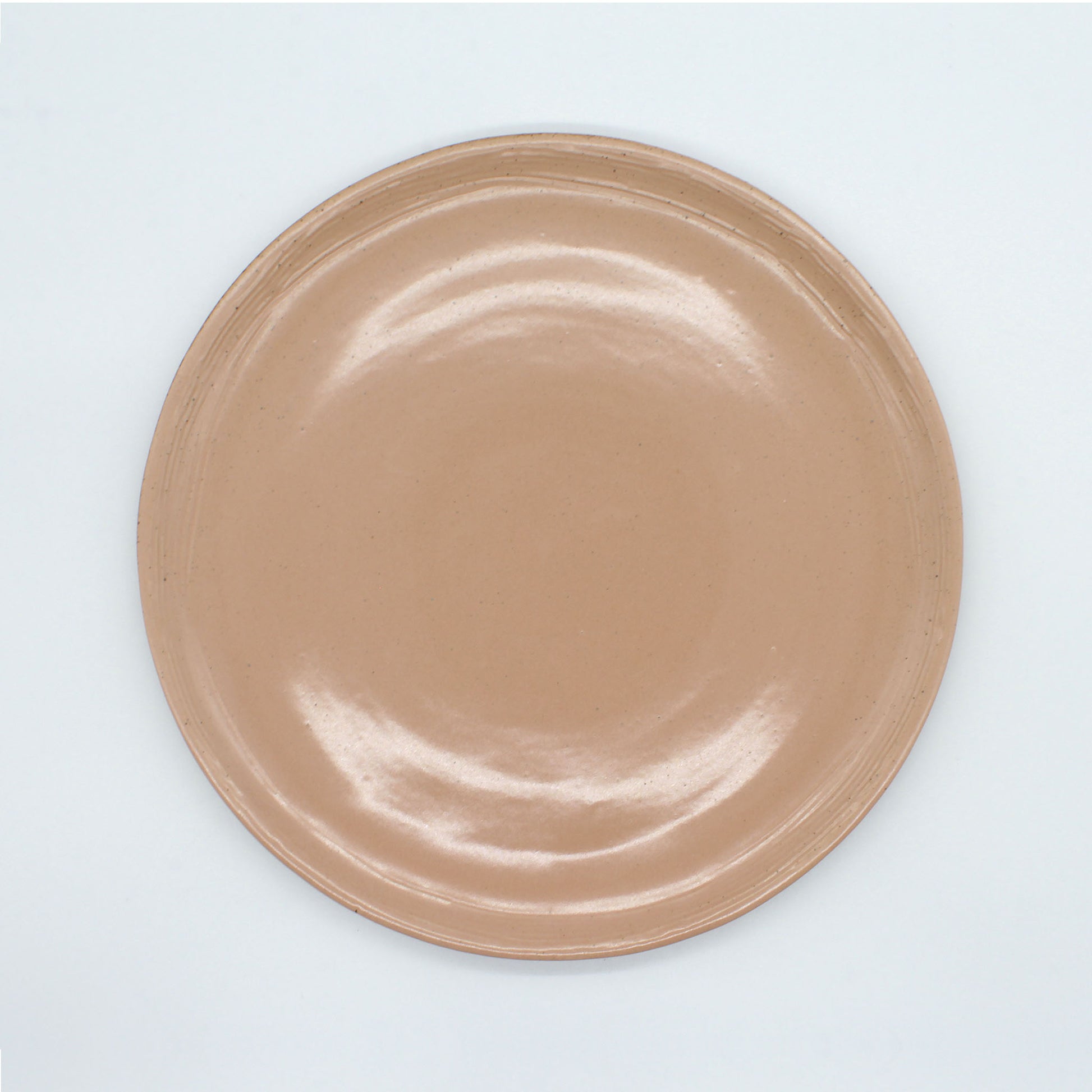 Beautiful handmade dinner plate from our Isariya collection, peach colour and  with fine dark speckles. A rustic, natural look.