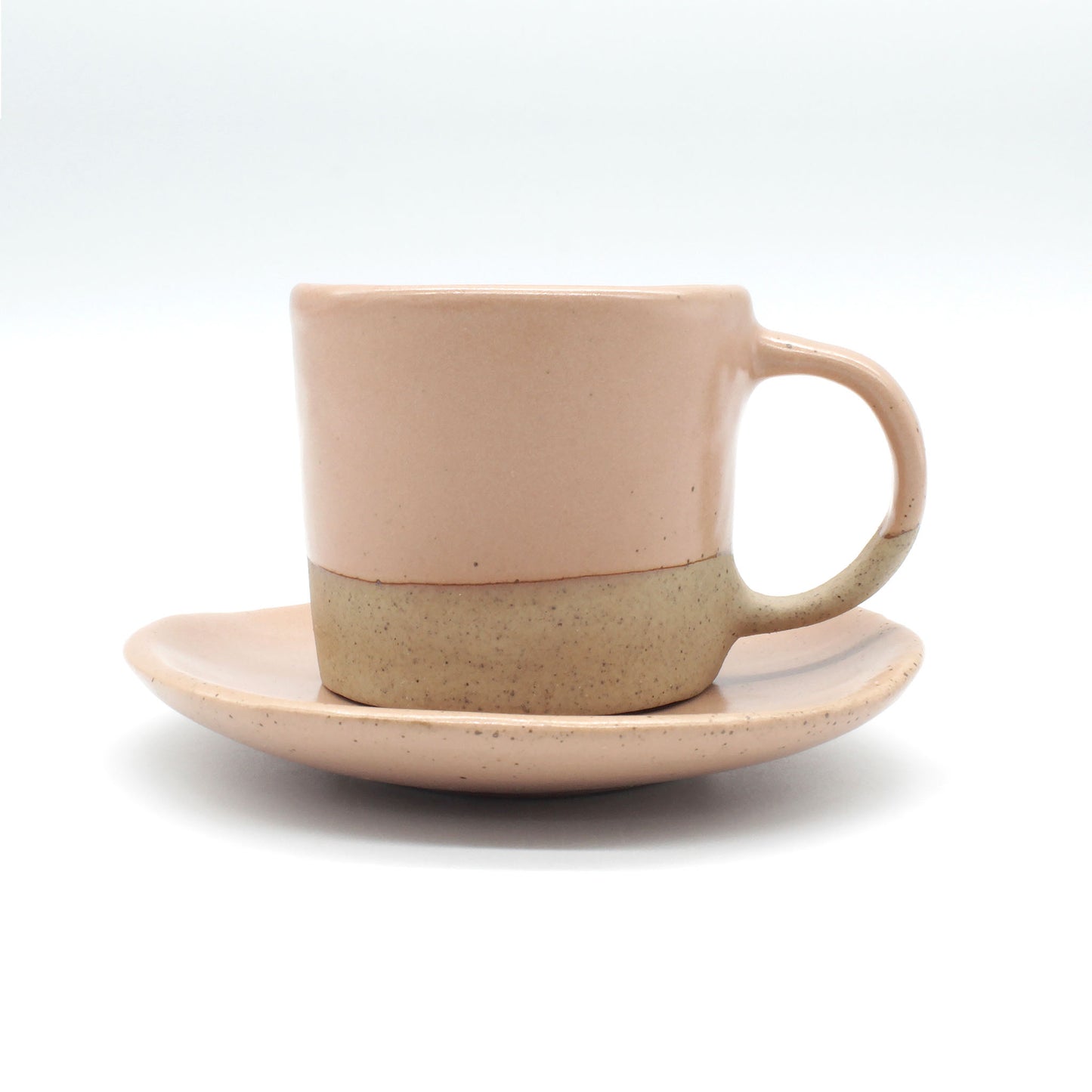 Handmade double espresso mug and saucer set in peach and clay colour  with fine dark speckles.