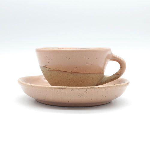 Side on view of handmade ceramic espresso set light pink, peach colour with natural clay speckle. Rustic natural look