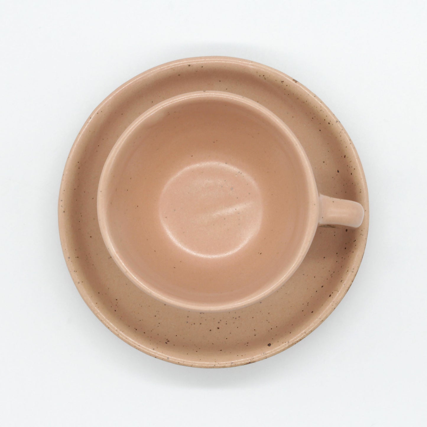 Top view of handmade ceramic espresso set from Thailand. Pink, peach colour with natural clay specks, rustic natural look