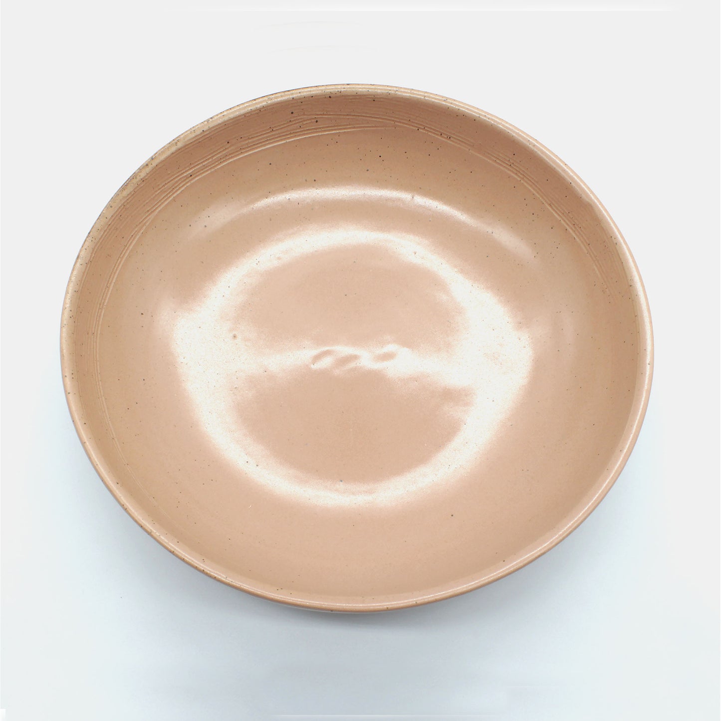 Top view of handmade ceramic pasta bowl from Thailand. Pink, peach colour with natural clay,, rustic natural look