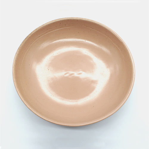 Top view of handmade ceramic pasta bowl from Thailand. Pink, peach colour with natural clay,, rustic natural look
