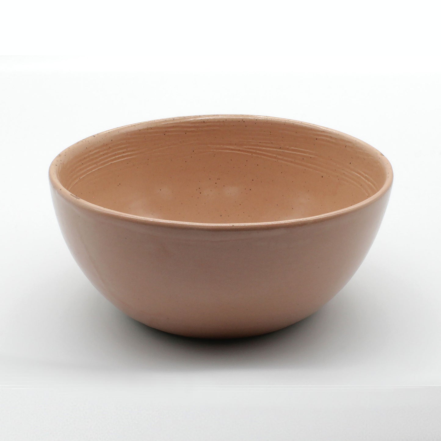 Side on view of beautiful handmade ceramic soup bowl from Thailand. Pink, peach colour with unique rustic look