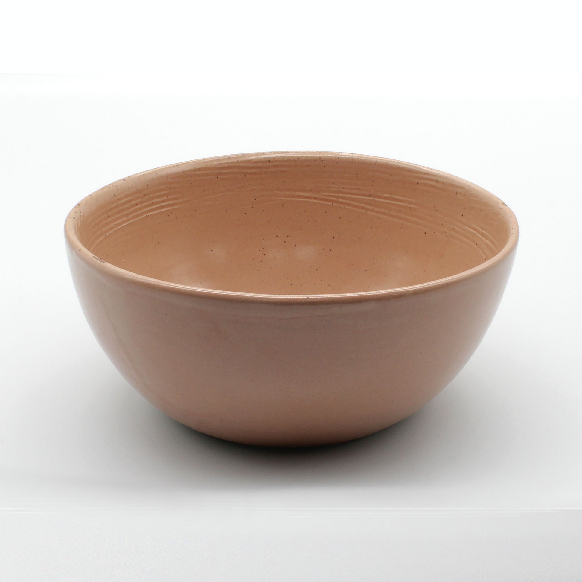 Side on view of beautiful handmade ceramic soup bowl from Thailand. Pink, peach colour with unique rustic look