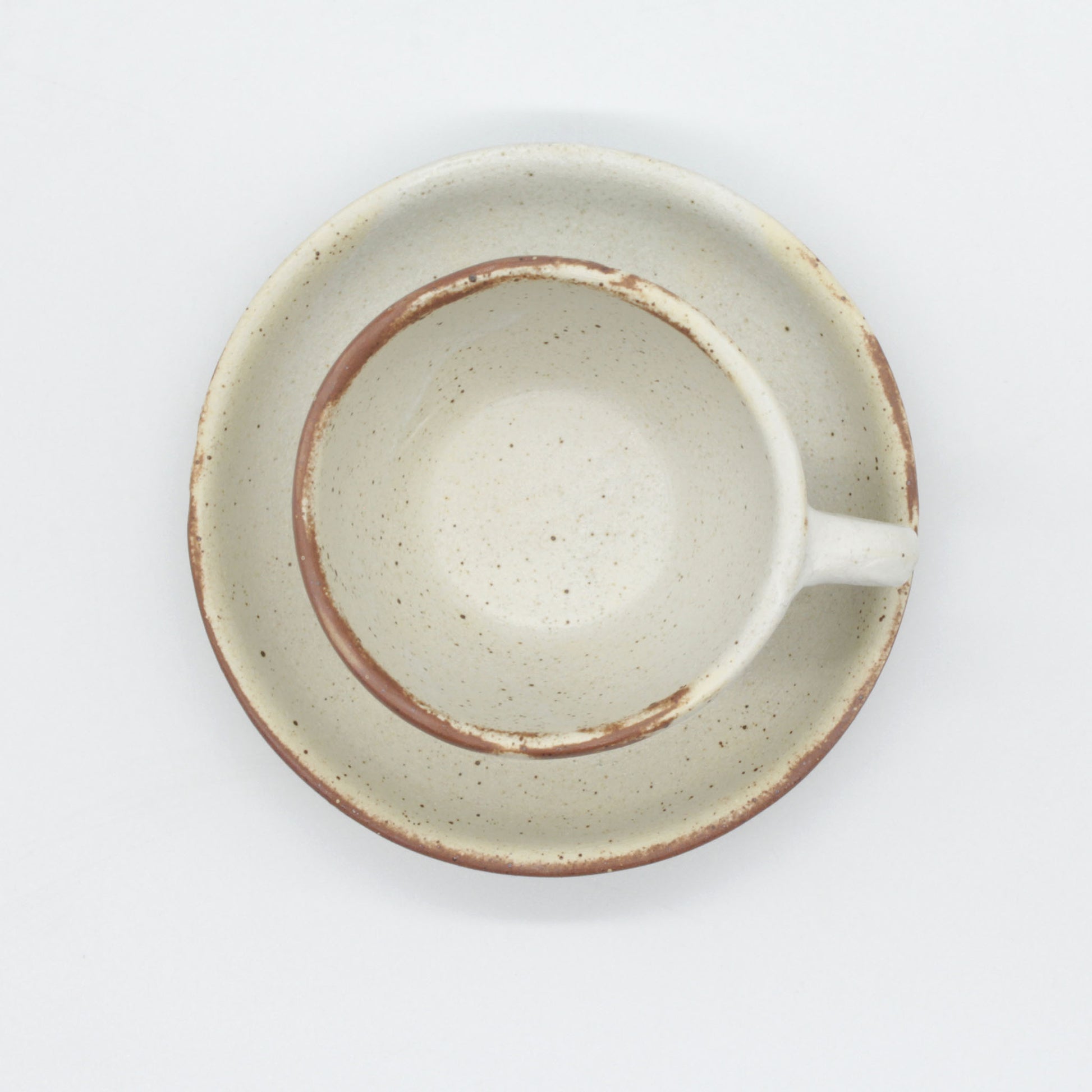 Lotus espresso cup and saucer - antique white in colour with touches of clay colour