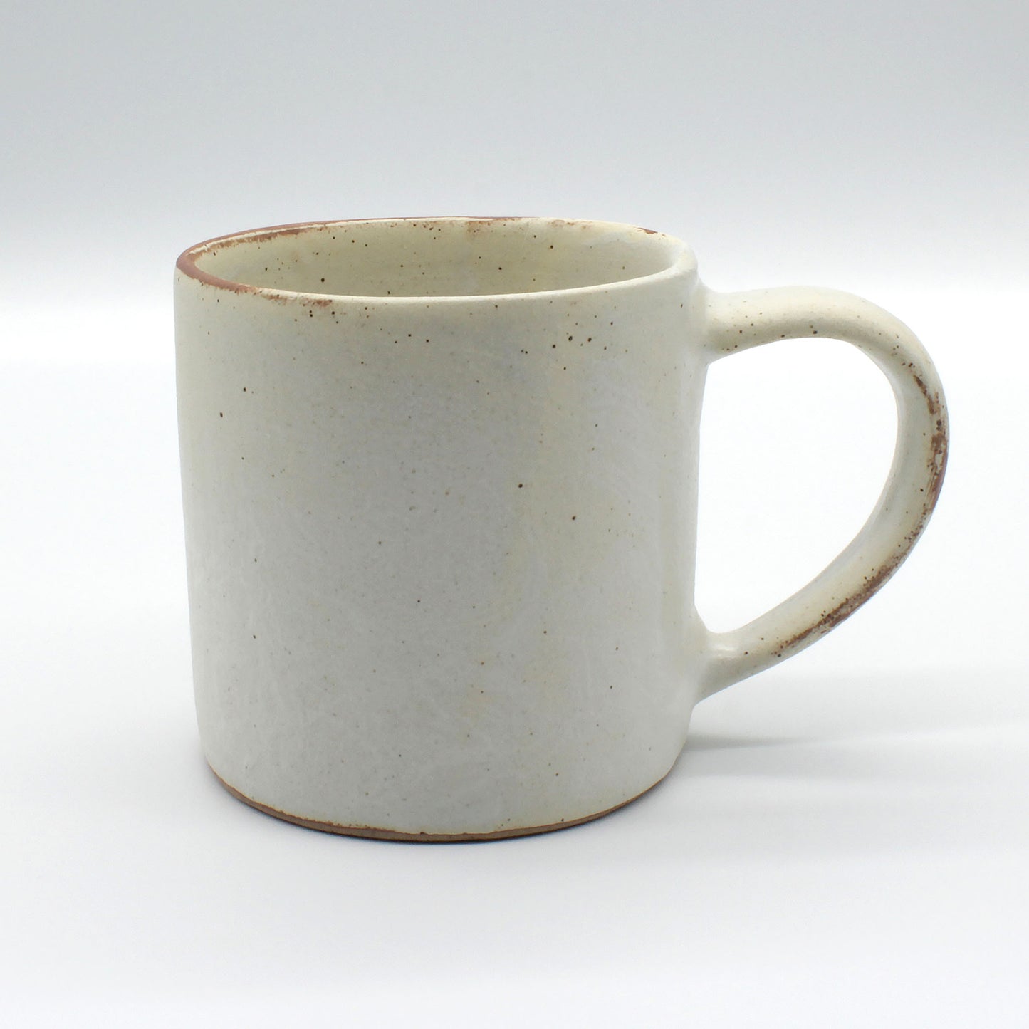 Handmade ceramic, antique white coffee mug with speckles of clay from Thailand