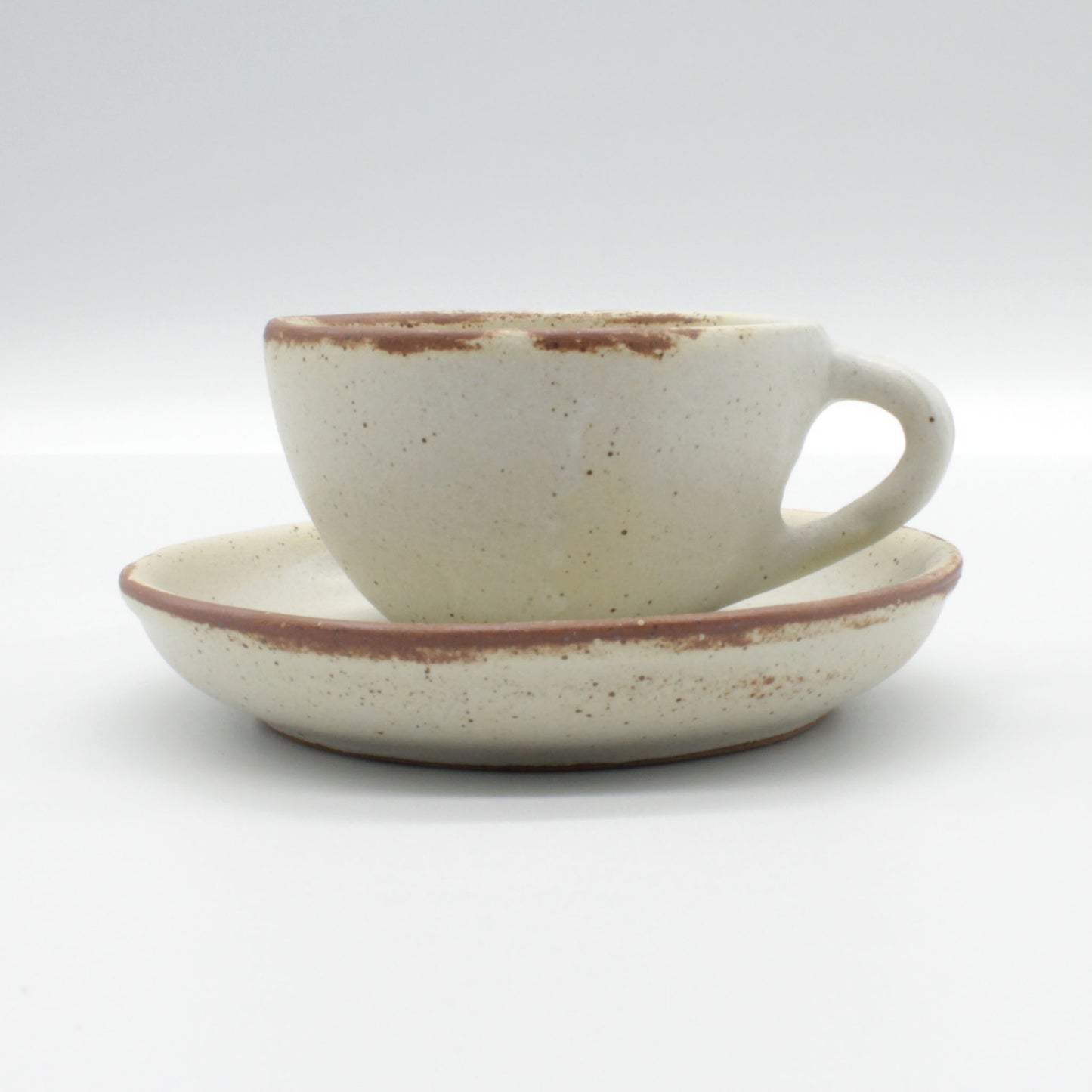 Handmade ceramic Lotus espresso cup and saucer - antique white in colour with touches of clay colour