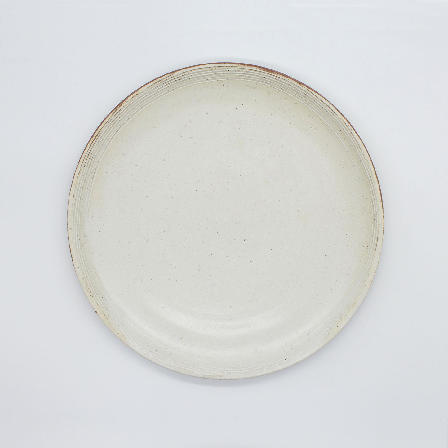 Handmade ceramic Lotus Dinner Plate - antique white in colour with black speckles