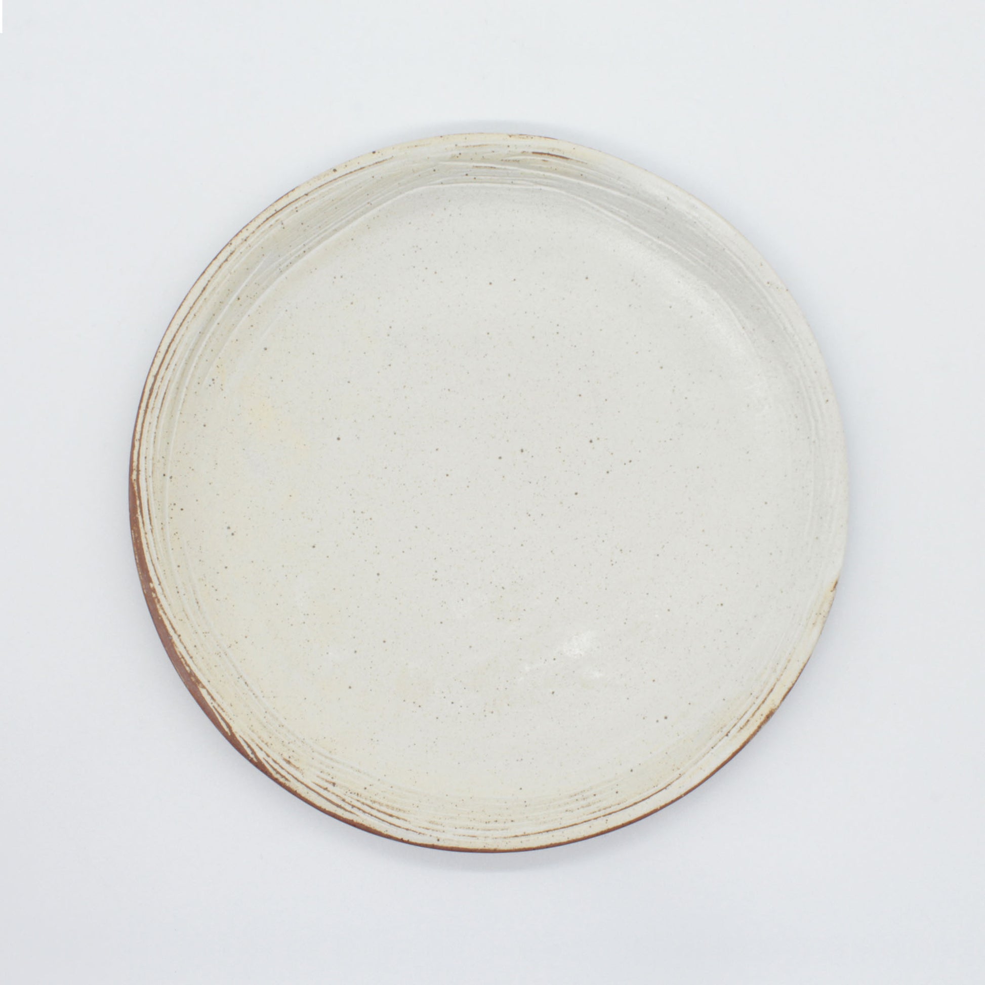 Aerial view of side plate from our Lotus collection – made of naturally speckled clay creating fine black spots in the texture of the clay