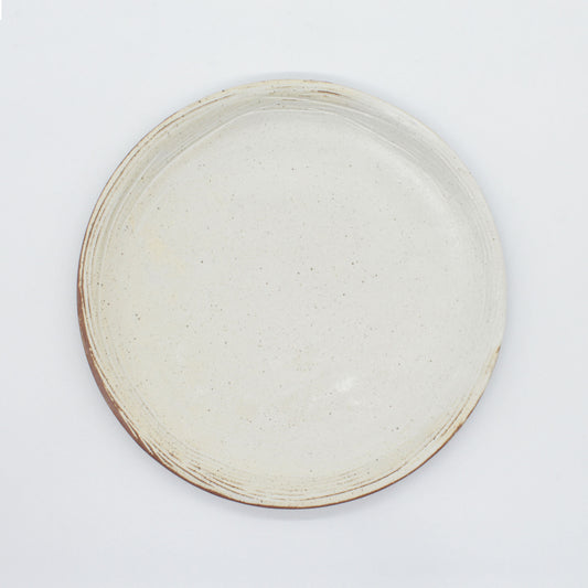 Aerial view of side plate from our Lotus collection – made of naturally speckled clay creating fine black spots in the texture of the clay