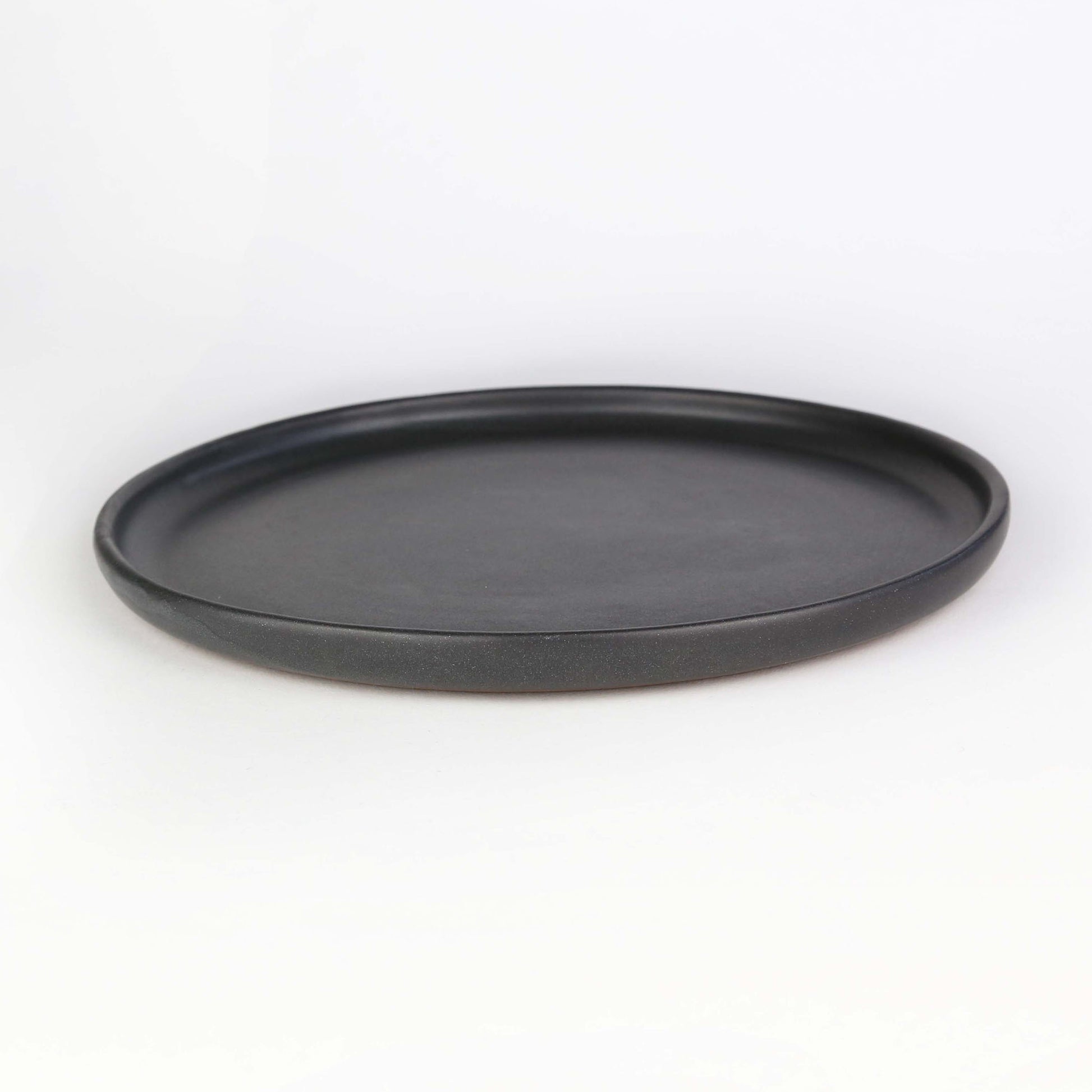 Side view of Tharn dinner plate. The Tharn collection is our black semi-gloss collection, that will enhance the appeal of each dish that you may serve.